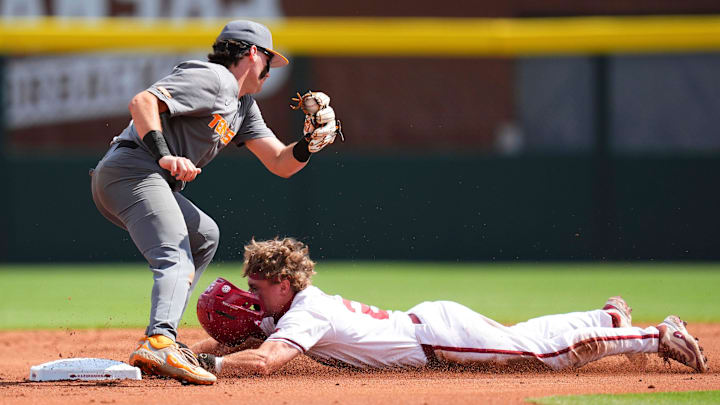 Tennessee's Gavin Kilen (6) fails to tag out Arkansas' Charles Davalan (24) at second base during game one of the NCAA baseball tournament Fayetteville Super Regional between Tennessee and Arkansas held at Baum-Walker Stadium on Saturday, June 7, 2025.