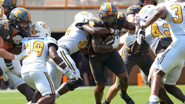 Chattanooga defensive edge Jestin Gilmore (33) tackles Tennessee running back Khalifa Keith (20) during a football game between Tennessee and Chattanooga at Neyland Stadium in Knoxville, Tenn., on Saturday, August 31, 2024.