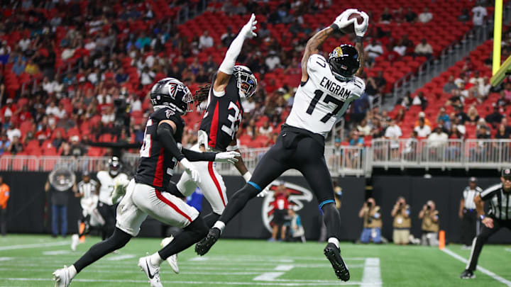 Aug 23, 2024; Atlanta, Georgia, USA; Jacksonville Jaguars tight end Evan Engram (17) catches a touchdown pass over Atlanta Falcons cornerback Jayden Price (36) and cornerback Kevin King (32) in the first quarter at Mercedes-Benz Stadium. 