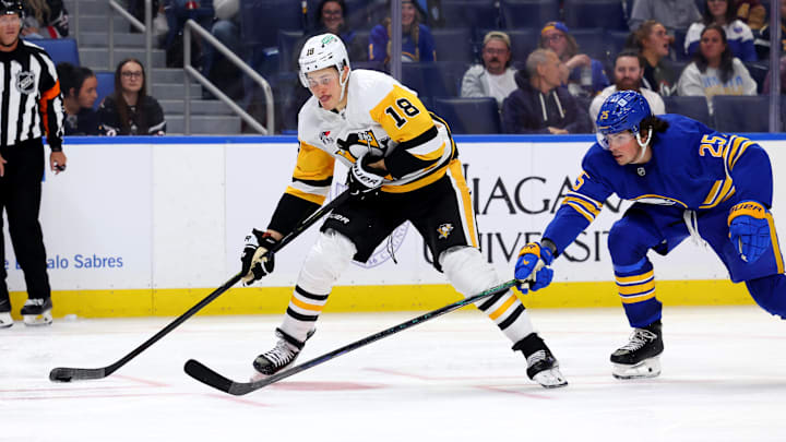 Sep 21, 2024; Buffalo, New York, USA;  Pittsburgh Penguins right wing Jesse Puljujarvi (18) looks to take a shot on goal as Buffalo Sabres defenseman Owen Power (25) defends during the third period at KeyBank Center. Mandatory Credit: Timothy T. Ludwig-Imagn Images