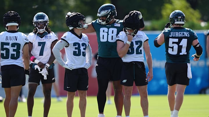 Jul 23, 2025; Philadelphia, PA, USA; Philadelphia Eagles offensive lineman Jordan Mailata (68) reacts with defensive back Cooper DeJean (33) and safety Reed Blankenship during training camp at NovaCare Complex. Mandatory Credit: Kyle Ross-Imagn Images
