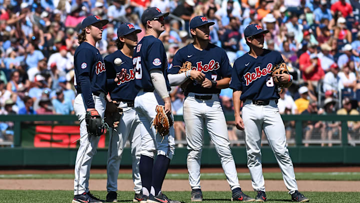Jun 26, 2022; Omaha, NE, USA; Ole Miss Rebels starting pitcher Hunter Elliott (26) and first baseman Tim Elko (25) and second baseman Peyton Chatagnier (1) and shortstop Jacob Gonzalez (7) and third baseman fielder Justin Bench (8) watch a video review in the game against the Oklahoma Sooners during the sixth inning at Charles Schwab Field. Mandatory Credit: Steven Branscombe-Imagn Images