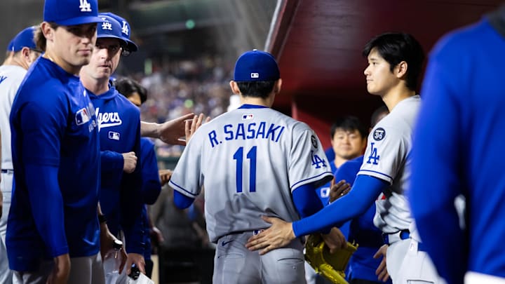 May 9, 2025; Phoenix, Arizona, USA; Los Angeles Dodgers pitcher Roki Sasaki (11) is greeted by Shohei Ohtani as he leaves the game in the fifth inning against the Arizona Diamondbacks at Chase Field. Mandatory Credit: Mark J. Rebilas-Imagn Images May 9, 2025; Phoenix, Arizona, USA; Los Angeles Dodgers pitcher Roki Sasaki (11) is greeted by Shohei Ohtani as he leaves the game in the fifth inning against the Arizona Diamondbacks at Chase Field. Mandatory Credit: Mark J. Rebilas-Imagn Images