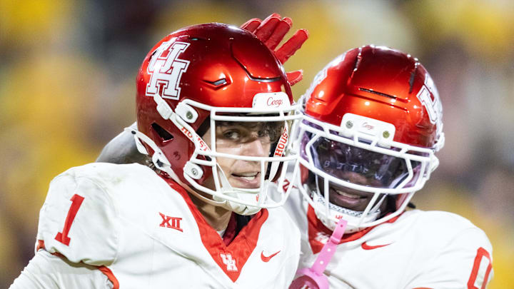Oct 25, 2025; Tempe, Arizona, USA; Houston Cougars quarterback Conner Weigman (1) celebrates a touchdown with wide receiver Amare Thomas (0) against the Arizona State Sun Devils in the second half at Mountain America Stadium. Mandatory Credit: Mark J. Rebilas-Imagn Images Oct 25, 2025; Tempe, Arizona, USA; Houston Cougars quarterback Conner Weigman (1) celebrates a touchdown with wide receiver Amare Thomas (0) against the Arizona State Sun Devils in the second half at Mountain America Stadium. Mandatory Credit: Mark J. Rebilas-Imagn Images