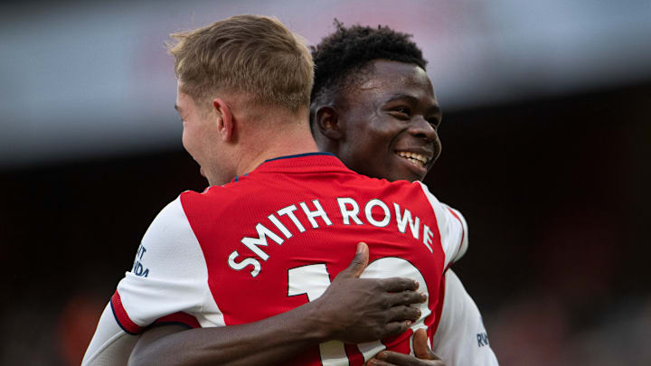 Bukayo Saka and Emile Smith Rowe embrace in 2021