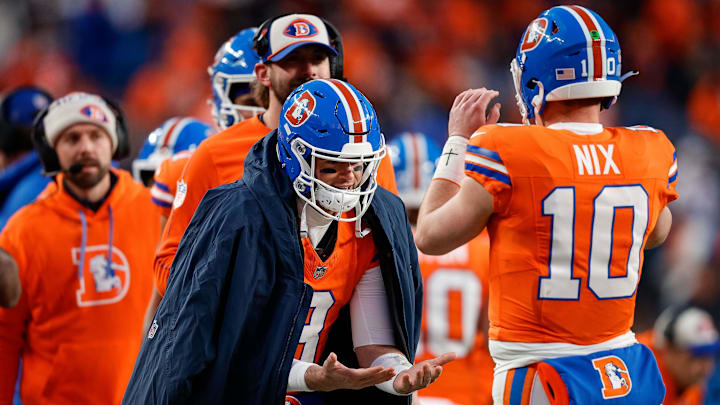 Jan 5, 2025; Denver, Colorado, USA; Denver Broncos quarterback Jarrett Stidham (8) celebrates with quarterback Bo Nix (10) after a play in the fourth quarter against the Kansas City Chiefs at Empower Field at Mile High. Mandatory Credit: Isaiah J. Downing-Imagn Images