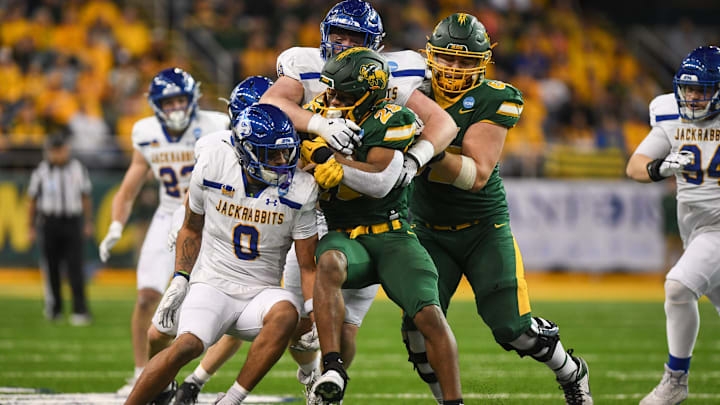 North Dakota State Bison running back CharMar Brown (25) gets tackled by South Dakota State defense on Saturday, Dec. 21, 2024, at Fargodome in Fargo, Nouth Dakot North Dakota State Bison running back CharMar Brown (25) gets tackled by South Dakota State defense on Saturday, Dec. 21, 2024, at Fargodome in Fargo, Nouth Dakot