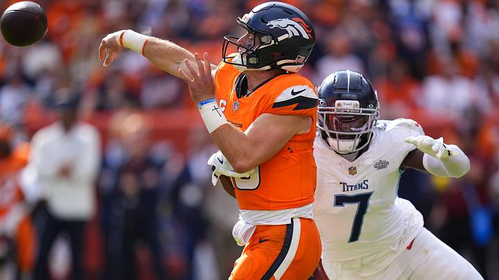 Sep 7, 2025; Denver, Colorado, USA; Denver Broncos quarterback Bo Nix (10) throws the ball past Tennessee Titans linebacker Oluwafemi Oladejo (7) in the second half at Empower Field at Mile High. Mandatory Credit: Ron Chenoy-Imagn Images