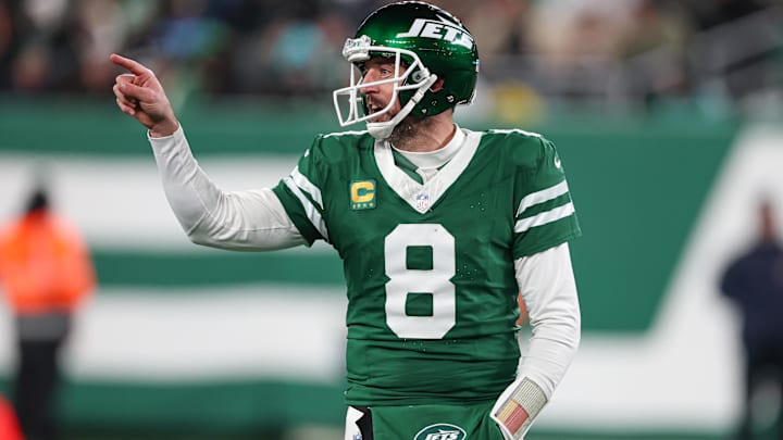 Jan 5, 2025; East Rutherford, New Jersey, USA; New York Jets quarterback Aaron Rodgers (8) gestures towards the Miami Dolphins bench during the second half at MetLife Stadium. Mandatory Credit: Vincent Carchietta-Imagn Images