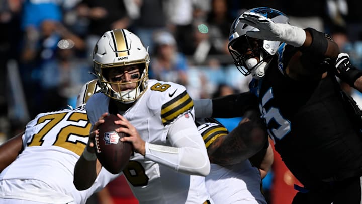 Nov 9, 2025; Charlotte, North Carolina, USA;  New Orleans Saints quarterback Tyler Shough (6) with the ball as Carolina Panthers defensive end Derrick Brown (95) pressures in the first quarter at Bank of America Stadium. Mandatory Credit: Bob Donnan-Imagn Images