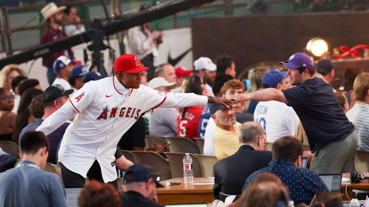 Jul 14, 2024; Ft. Worth, TX, USA;  Christian Moore celebrates with fans after being selected by the Los Angeles Angels as the eighth player taken during the first round of the MLB Draft at Cowtown Coliseum. Mandatory Credit: Kevin Jairaj-Imagn Images