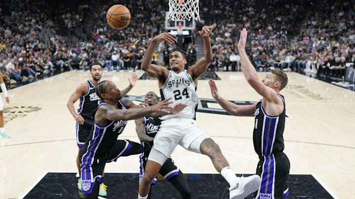 Nov 11, 2024; San Antonio, Texas, USA; San Antonio Spurs guard Devin Vassell (24) loses the ball while defended by Sacramento Kings guard DeMar DeRozan (10) and center Domantas Sabonis (11) during the second half at Frost Bank Center. Mandatory Credit: Scott Wachter-Imagn Images