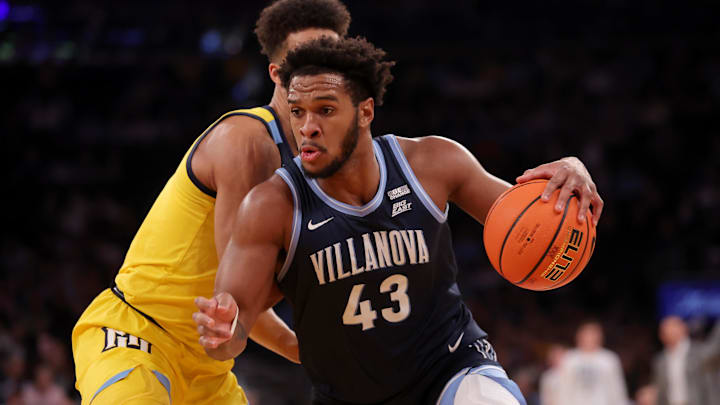 Mar 14, 2024; New York City, NY, USA; Villanova Wildcats forward Eric Dixon (43) drives to the basket against Marquette Golden Eagles forward Oso Ighodaro (13) during the first half at Madison Square Garden. Mandatory Credit: Brad Penner-Imagn Images