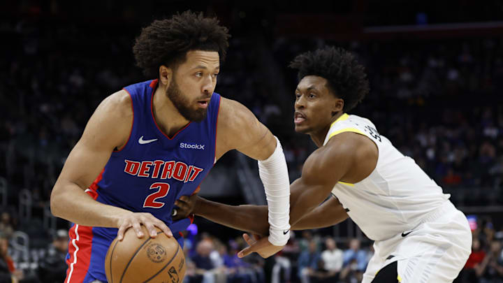 Dec 19, 2024; Detroit, Michigan, USA;  Detroit Pistons guard Cade Cunningham (2) dribbles on Utah Jazz guard Collin Sexton (2) in the first half at Little Caesars Arena. Mandatory Credit: Rick Osentoski-Imagn Images