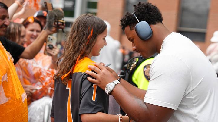 Tennessee offensive lineman Nic Moore (58) signs an autograph during the Vol Walk for Tennessee's home opening NCAA college football game against East Tennessee State University on September 6, 2025, in Knoxville, Tennessee.
