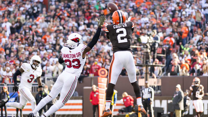 Nov 5, 2023; Cleveland, Ohio, USA; Cleveland Browns wide receiver Amari Cooper (2) catches a tipped ball for a touchdown under coverage by Arizona Cardinals cornerback Antonio Hamilton Sr. (33) during the second quarter at Cleveland Browns Stadium. Mandatory Credit: Scott Galvin-USA TODAY Sports