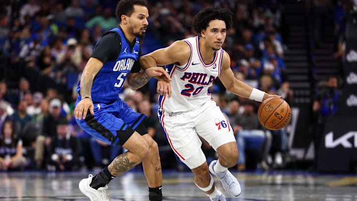 Nov 15, 2024; Orlando, Florida, USA; Philadelphia 76ers guard Jared McCain (20) drives to the basket past Orlando Magic guard Cole Anthony (50) in the second quarter at Kia Center. Mandatory Credit: Nathan Ray Seebeck-Imagn Images