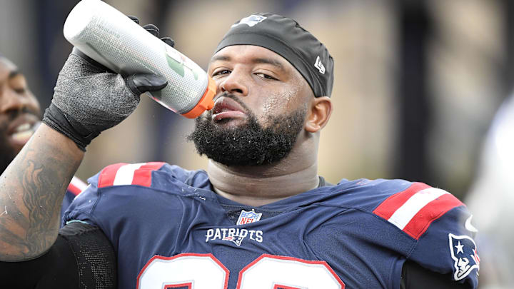 Nov 6, 2022; Foxborough, Massachusetts, USA;  New England Patriots defensive tackle Davon Godchaux (92) takes a drink during the second half against the Indianapolis Colts at Gillette Stadium. Mandatory Credit: Bob DeChiara-Imagn Images