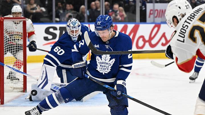 Apr 11, 2026; Toronto, Ontario, CAN;  Toronto Maple Leafs defenseman Jake McCabe (22) blocks a shot by Florida Panthers forward Eetu Luostarinen (27) in the third period at Scotiabank Arena. Mandatory Credit: Dan Hamilton-Imagn Images