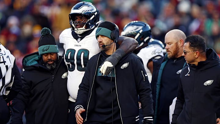Dec 22, 2024; Landover, Maryland, USA; Philadelphia Eagles head coach Nick Sirianni helps defensive tackle Jordan Davis (90) off the field during the second quarter against the Washington Commanders at Northwest Stadium. Mandatory Credit: Peter Casey-Imagn Images