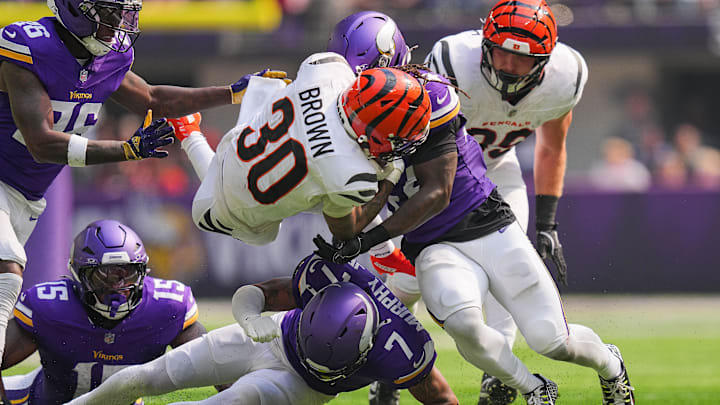 Sep 21, 2025; Minneapolis, Minnesota, USA; Cincinnati Bengals running back Chase Brown (30) is tackled during the first half against the Minnesota Vikings at U.S. Bank Stadium. Mandatory Credit: Brad Rempel-Imagn Images