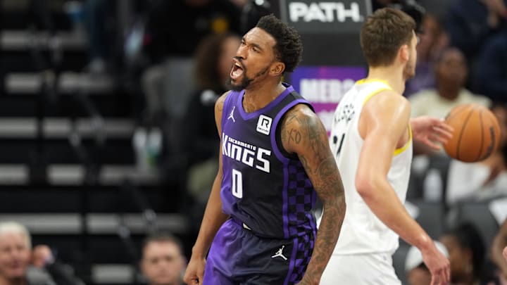 Dec 8, 2024; Sacramento, California, USA; Sacramento Kings guard Malik Monk (0) reacts after scoring against the Utah Jazz during the third quarter at Golden 1 Center. Mandatory Credit: Darren Yamashita-Imagn Images