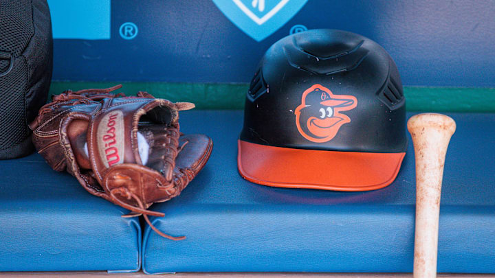 Apr 21, 2024; Kansas City, Missouri, USA; Baltimore Orioles hat and glove sits in the dugout during the ninth inning against the Kansas City Royals at Kauffman Stadium. Mandatory Credit: William Purnell-Imagn Images