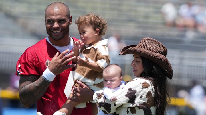 Jul 22, 2025; Oxnard, CA, USA; Dallas Cowboys quarterback Dak Prescott (4) visits with fiancee Sarah Jane Ramos and daughters MJ Rose Prescott (right) and Aurora Prescott (left) during training camp at the River Ridge Fields.