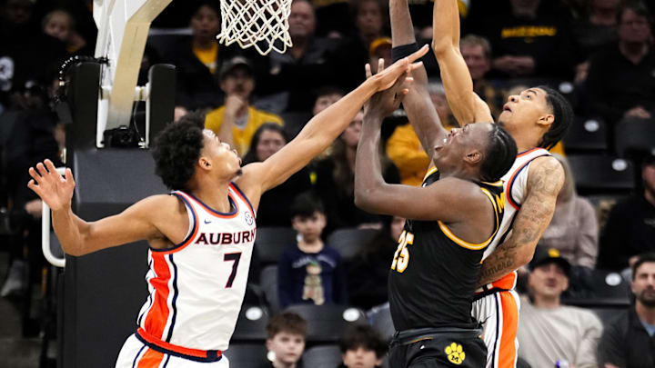 Jan 14, 2026; Columbia, Missouri, USA; Missouri Tigers guard Mark Mitchell (25) shoots as Auburn Tigers forward Keyshawn Hall (7) defends during the second half of the game at Mizzou Arena. Mandatory Credit: Denny Medley-Imagn Images