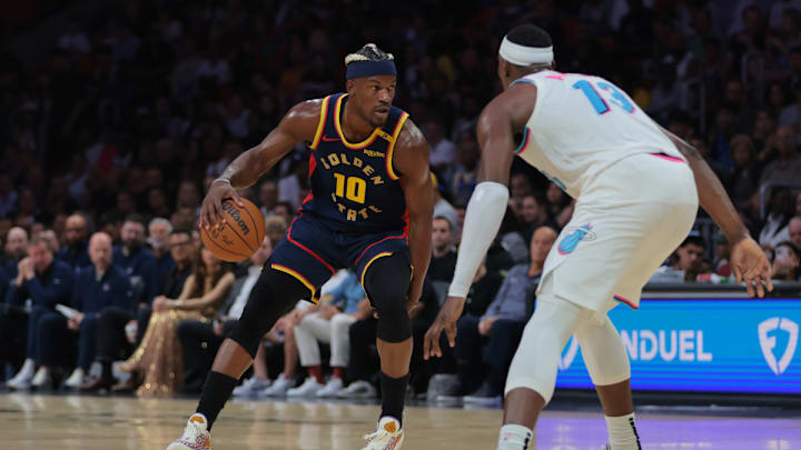 Golden State Warriors forward Jimmy Butler III (10) dribbles the basketball as Miami Heat center Bam Adebayo (13) defends during the first quarter at Kaseya Center. Golden State Warriors forward Jimmy Butler III (10) dribbles the basketball as Miami Heat center Bam Adebayo (13) defends during the first quarter at Kaseya Center.