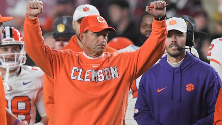 Nov 25, 2023; Columbia, South Carolina, USA; Clemson Tigers head coach Dabo Swinney celebrates with offensive coordinator Garrett Riley as time expires against the South Carolina Gamecocks at Williams-Brice Stadium.  Clemson won 16-7. Mandatory Credit: Ken Ruinard-Imagn Images