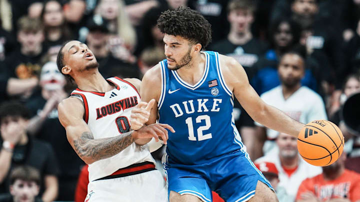 Duke forward Cameron Boozer drives against Louisville forward Khani Rooths. Duke forward Cameron Boozer drives against Louisville forward Khani Rooths.