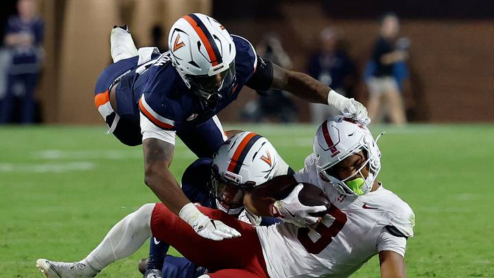 Sep 20, 2025; Charlottesville, Virginia, USA; Stanford Cardinal wide receiver C.J. Williams (3) is tackled after catching a pass by Virginia Cavaliers cornerback Emmanuel Karnley (19) and Cavaliers linebacker Kam Robinson (5) during the fourth quarter at Scott Stadium. Mandatory Credit: Geoff Burke-Imagn Images Sep 20, 2025; Charlottesville, Virginia, USA; Stanford Cardinal wide receiver C.J. Williams (3) is tackled after catching a pass by Virginia Cavaliers cornerback Emmanuel Karnley (19) and Cavaliers linebacker Kam Robinson (5) during the fourth quarter at Scott Stadium. Mandatory Credit: Geoff Burke-Imagn Images