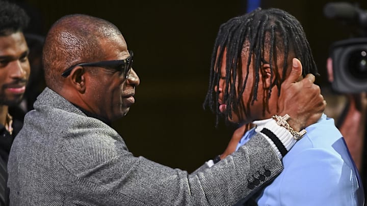 Dec 14, 2024; New York, NY, USA; Colorado Buffaloes wide receiver/cornerback Travis Hunter with head coach Deion Sanders after winning the 2024 Heisman Trophy. Mandatory Credit: Todd Van Emst/Heisman Trust via Imagn Images