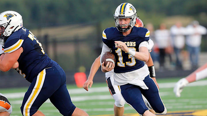 Hillsdale High School's Kael Lewis (13) carries the ball against Lucas High School during high school football action Friday, Aug. 29, 2025 at Hillsdale High School. TOM E. PUSKAR/MANSFIELD NEWS JOURNAL