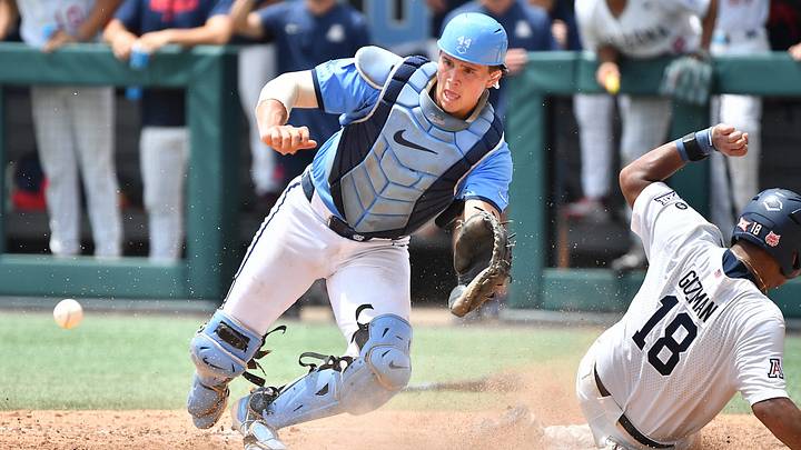 Arizona's Adonys Guzman (18) slides into home plate to score beating the throw to North Carolina catcher Luke Stevenson (44) . The North Carolina Tar Heels and the Arizona Wildcats met in game two of the NCAA Division 1 Super Regionals in Chapel Hill, N.C. on June 7, 2025.