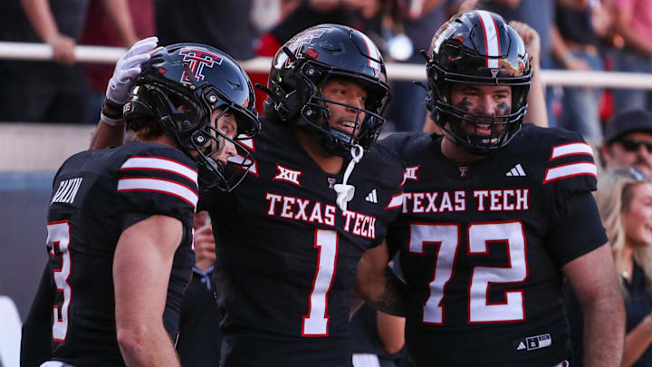 Texas Tech's Reggie Virgil celebrates his third touchdown against UCF with teammates Coy Eakin (3) and Sheridan Wilson during a Big 12 Conference football game