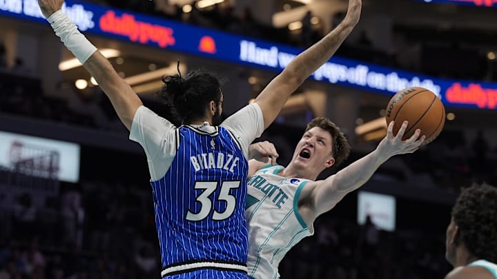 Oct 30, 2025; Charlotte, North Carolina, USA; Charlotte Hornets guard Kon Knueppel (7) drives to the basket against Orlando Magic center Goga Bitadze (35) during the second half at Spectrum Center. Mandatory Credit: Jim Dedmon-Imagn Images