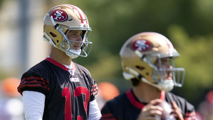 Jun 11, 2025; Santa Clara, CA, USA; San Francisco 49ers quarterback Brock Purdy (13) watches Tanner Mordecai (14) throw a pass during a team OTA at Levi's Stadium. Mandatory Credit: D. Ross Cameron-Imagn Images Jun 11, 2025; Santa Clara, CA, USA; San Francisco 49ers quarterback Brock Purdy (13) watches Tanner Mordecai (14) throw a pass during a team OTA at Levi's Stadium. Mandatory Credit: D. Ross Cameron-Imagn Images