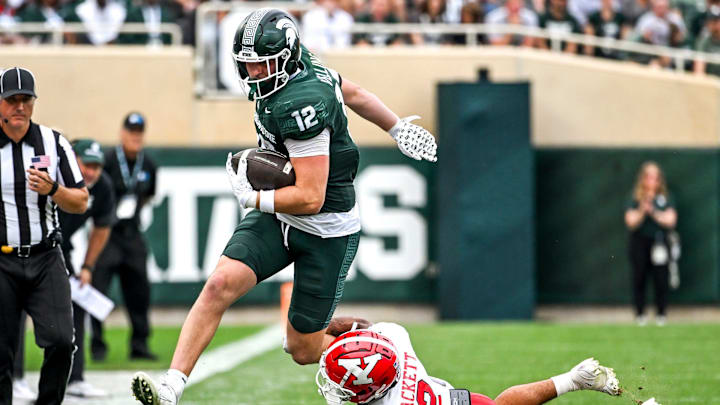 Michigan State's Jack Velling, left, catches a pass as Youngstown State's Isaiah Hackett defends during the third quarter on Saturday, Sept. 13, 2025, at Spartan Stadium in East Lansing.