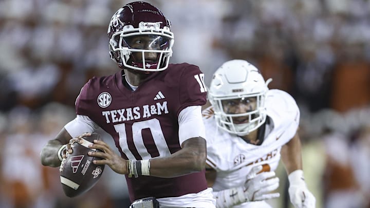 Texas A&M Aggies quarterback Marcel Reed looks for an open receiver as Texas Longhorns linebacker Trey Moore defends during the fourth quarter at Kyle Field.