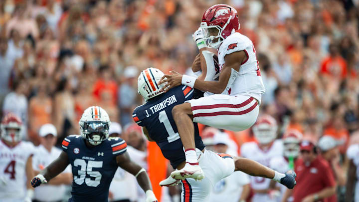 Arkansas Razorbacks quarterback Taylen Green (10) fails to hurdle over Auburn Tigers defensive back Jerrin Thompson (1) as Auburn Tigers take on Arkansas Razorbacks at Jordan-Hare Stadium in Auburn, Ala., on Saturday, Sept. 21, 2024. Arkansas Razorbacks lead Auburn Tigers 7-0 at halftime.