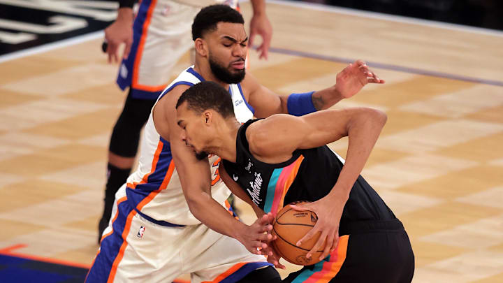Mar 1, 2026; New York, New York, USA; New York Knicks center Karl-Anthony Towns (32) defends against San Antonio Spurs forward Victor Wembanyama (1) during the first quarter at Madison Square Garden. Mandatory Credit: Brad Penner-Imagn Images