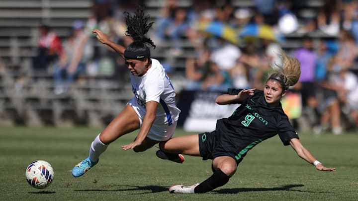 Bridgette Marin-Valencia of UCLA and Kaitlyn Paculba of Oregon fight for a ball in a game from October 2023.  Coming off a 5-11-2 season last year the Ducks have a new look and a new attitude this season behind first-year coach Tracy Joyner.