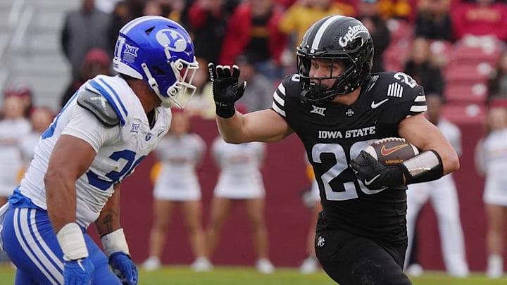 Iowa State Cyclones' running back Carson Hansen (26) runs with the ball for a first down as BYU Cougars linebacker Max Alford (30) defends at Jack Trice Stadium on Oct. 25, 2025, in Ames, Iowa. Iowa State Cyclones' running back Carson Hansen (26) runs with the ball for a first down as BYU Cougars linebacker Max Alford (30) defends at Jack Trice Stadium on Oct. 25, 2025, in Ames, Iowa.