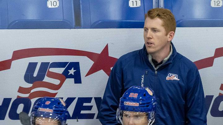 Aug 2, 2024; Plymouth, MI, USA; USA’s head coach Dave Carle watches the action from the bench against Sweden during the first period of the 2024 World Junior Summer Showcase at USA Hockey Arena. Mandatory Credit: David Reginek-Imagn Images