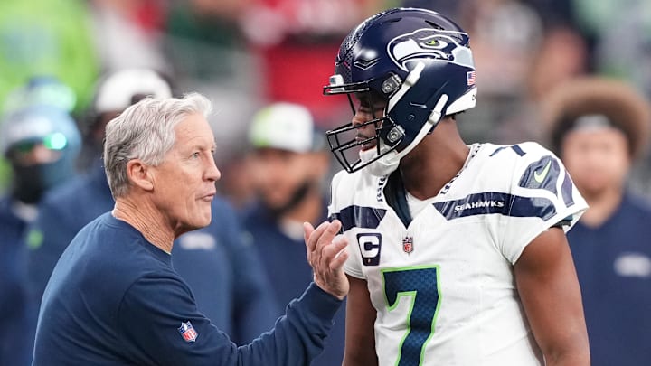 Jan 7, 2024; Glendale, Arizona, USA; Seattle Seahawks head coach Pete Carroll talks with Seattle Seahawks quarterback Geno Smith (7) during the first half of the game against the Arizona Cardinals at State Farm Stadium. Mandatory Credit: Joe Camporeale-Imagn Images