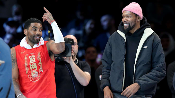 Jan 26, 2023; Brooklyn, New York, USA; Brooklyn Nets guard Kyrie Irving (11) and forward Kevin Durant (7) react after being announced as 2013 all stars during the second quarter against the Detroit Pistons at Barclays Center. Mandatory Credit: Brad Penner-Imagn Images