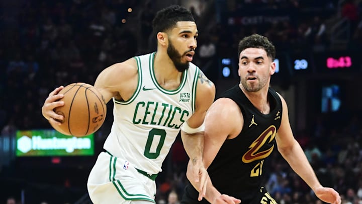 Mar 5, 2024; Cleveland, Ohio, USA;  Boston Celtics forward Jayson Tatum (0) drives to the basket against Cleveland Cavaliers forward Georges Niang (20) during the first half at Rocket Mortgage FieldHouse. Mandatory Credit: Ken Blaze-Imagn Images