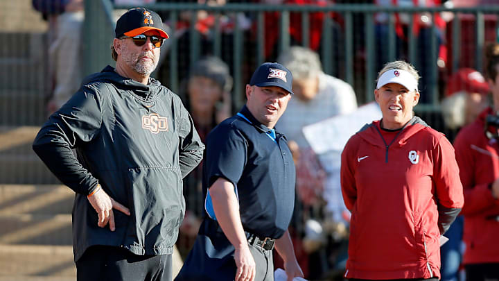 OSU coach Kenny Gajewski and OU coach Patty Gasso talk with an official before a Bedlam softball. OSU coach Kenny Gajewski and OU coach Patty Gasso talk with an official before a Bedlam softball.